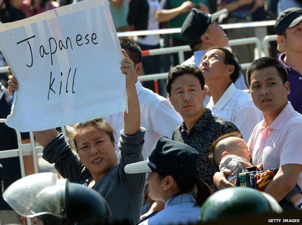 A woman holds up an anti-Japanese sign during a protest in September 2012
