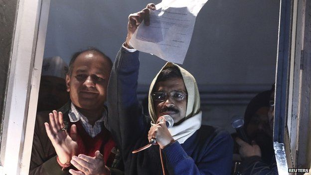 Arvind Kejriwal, chief of the Aam Aadmi Party, shows his resignation letter to his supporters as he quits as Delhi Chief Minister on 14 February 2014