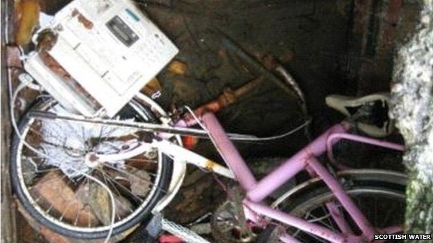 bike and fax machine in sewer