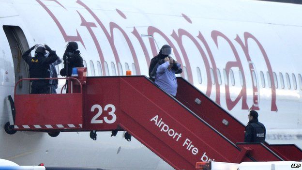 Police evacuate passengers off the Ethiopian airlines plane