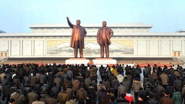 This picture taken on February 16, 2014 by North Korea's official Korean Central News Agency (KCNA) shows North Korean people offering flower bouquets to the statues of late leaders Kim Il-Sung (L) and Kim Jong-Il at Mansu Hill in Pyongyang for the 72nd birth anniversary of Kim Jong-Il