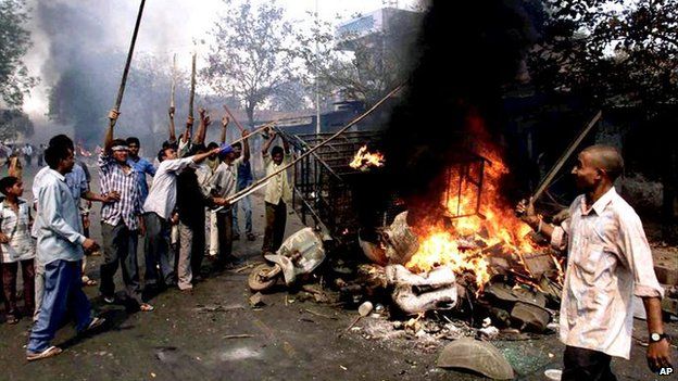 Youths burn vehicles and debris during riots in Ahmadabad, Gujarat, on 28 February, 2002.