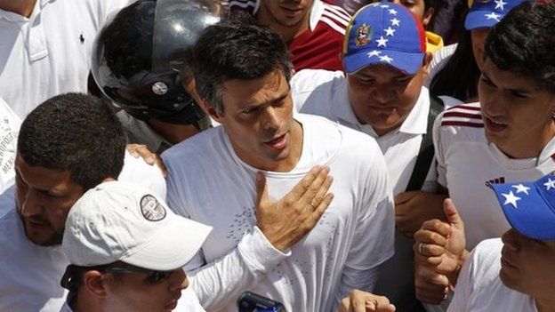 Venezuela's opposition leader Leopoldo Lopez (C), wanted on charges of fomenting deadly violence, walks through a demonstration of his supporters opposed to the government of Nicolas Maduro in Caracas on 18 February 2014.