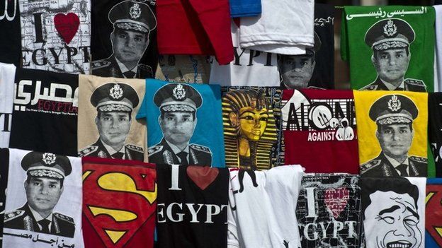Shirts, some depicting Abdel Fattah al-Sisi, is displayed for sale on Tahrir Square during a gathering marking the 40th anniversary of the 1973 Arab-Israeli war on October 6, 2013 in the Egyptian capital Cairo. Egypt braced for rival demonstrations called by supporters and opponents of deposed Islamist president Mohamed Morsi during the anniversary's festivities. AFP PHOTO / KHALED DESOUKIKHALED DESOUKI/AFP/Getty Images