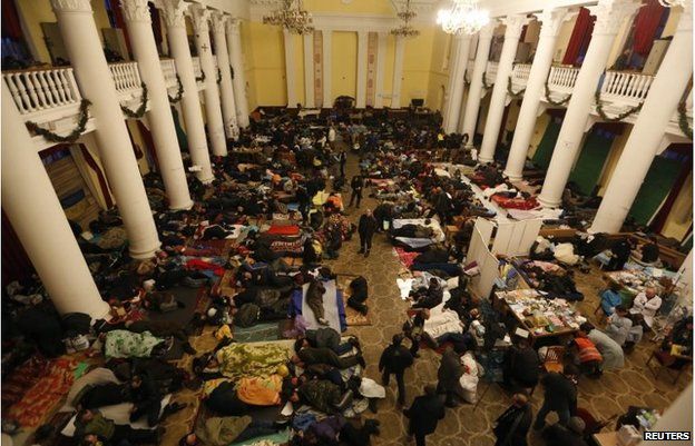 Anti-government protesters sleep in City Hall in Kiev February 21