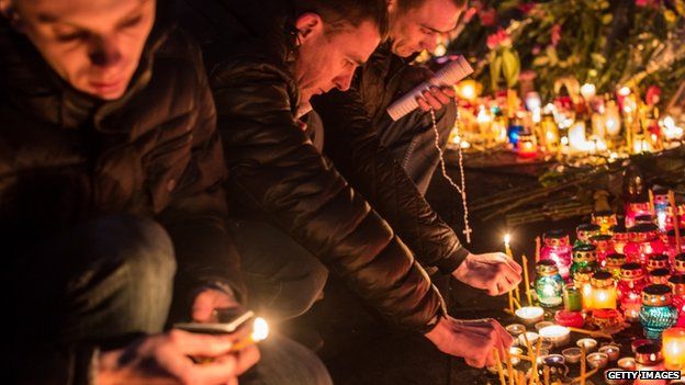 People light candles at a memorial for anti-government protesters killed in clashes with police in Independence Square on February 23, 2014 in Kiev, Ukraine.