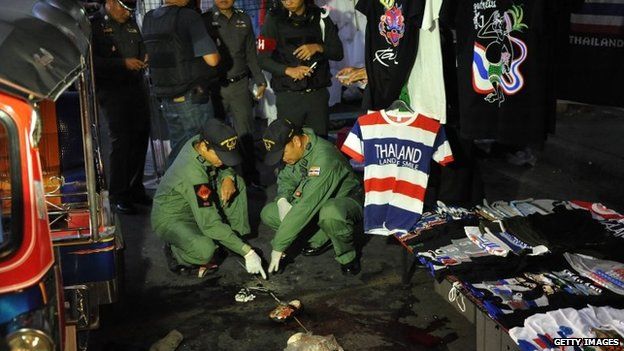 Bomb squad police examine the scene of a deadly explosion at an anti-government rally on 23 February 2014 in Bangkok