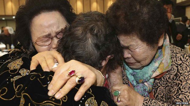 North Korean Kim Tae Un (C), 78, and her South Korean sisters Kim Sa-bun (L) and Kim Young-sun cry as they hug each other during their family reunion at the Mount Kumgang resort in North Korea, 23 February 2014