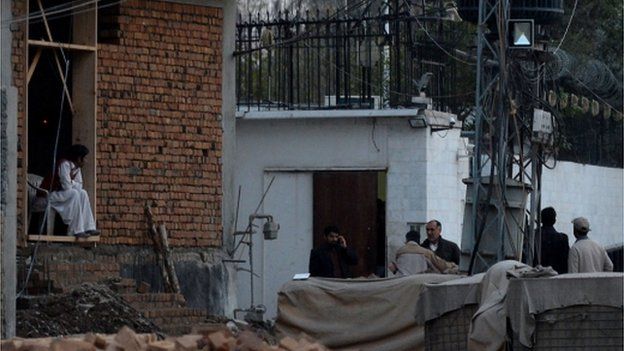 Pakistani security personnel gather outside the Iranian consulate following a suicide bomb attack in Peshawar on February on February 24, 2014.