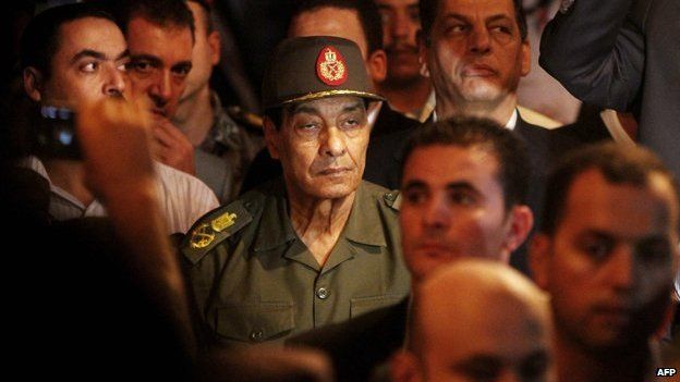 Egyptian Field Marshal Mohammed Hussein Tantawi (C) arrives at the funeral of former Vice-President Omar Suleiman in Cairo on 21 July 2012