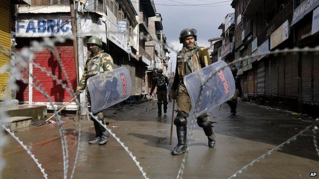 Government forces patrol a deserted street during a strike in Srinagar on Feb 11, 2014