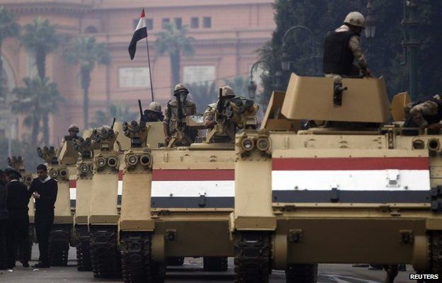 Soldiers in armoured personnel carriers arrive in Tahrir Square after clashes with pro-Morsi protesters in Cairo (1 December 2013)