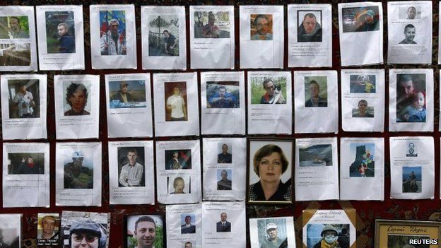 Photos of some of those killed in recent violence are seen at a makeshift memorial in Kiev's Independence Square