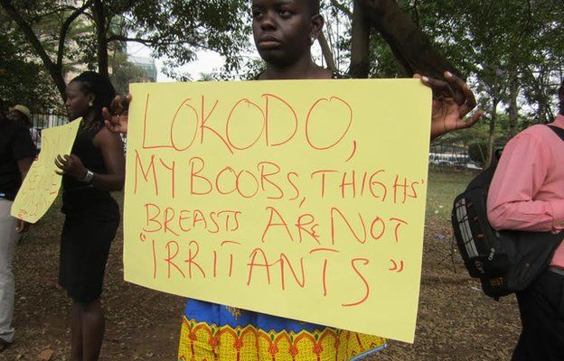 Ugandan women holding up protest placards about the anti-pornography laws which ban the wearing of miniskirts