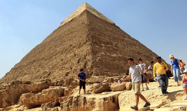 A tourist walks in front the Great Pyramid of Khafre in Giza, on 30 March 2010