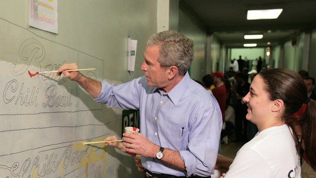 President George W Bush helps paint a mural in Washington DC in 2007