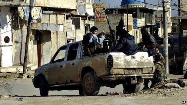 Fighters from the Islamic State of Iraq and the Levant (ISIS) marching in Raqqa, Syria