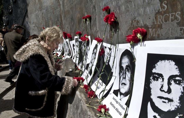 Flowers are laid in Santiago, Chile, in memory of victims of the Pinochet government, September 2013