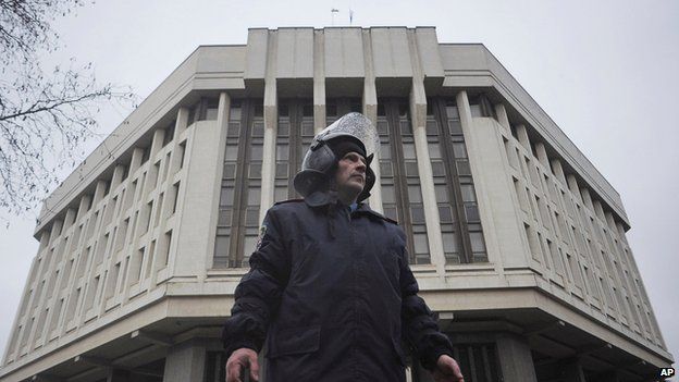 Ukrainian police officer outside a local government building in Simferopol, Crimea, on 27 February 2014