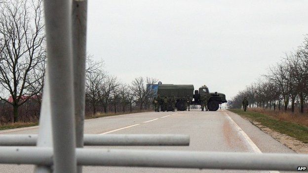 Unidentified men - whom the Ukrainian interior minister says are Russian Naval troops - block a road to a military airport Belbek not far from Sevastopol