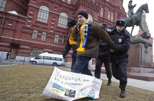 Police arrest a pro-Ukraine protester near the Kremlin in Moscow, 2 March