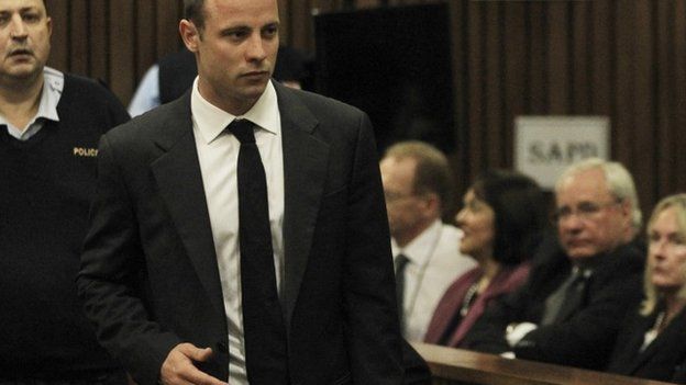 Oscar Pistorius is watched by June Steenkamp (right) the mother of Reeva Steenkamp, as he arrives for his trial at the high court in Pretoria, South Africa -3 March 2014