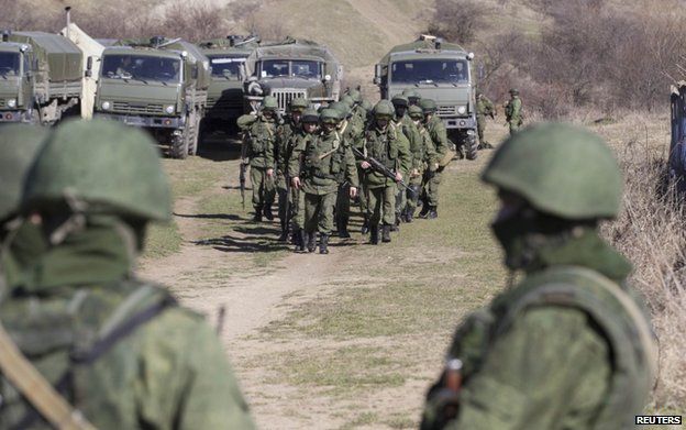 Soldiers believed to be Russians outside the territory of a Ukrainian military unit in Crimean village of Perevalnoye