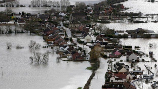 Water surrounds flooded propeties in the village of Moorland on the Somerset Levels