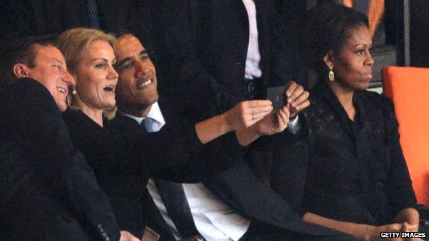 US President Barack Obama, UK Prime Minister David Cameron, and Denmark's PM Helle Thorning-Schmidt take an impromptu photograph of themselves at the memorial service for the late South African President Nelson Mandela.