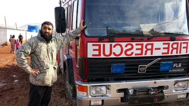 Abdul Waheed Majeed with a truck at a refugee camp