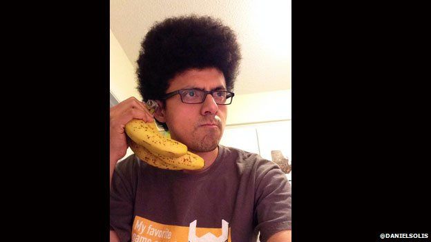 Daniel Solis poses with a bunch of bananas