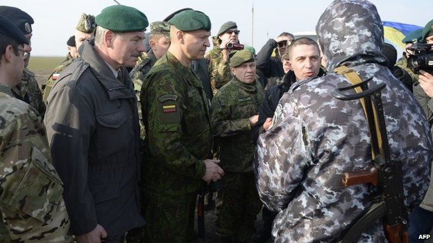 OSCE military observers talk to a pro-Russian soldier in an attempt to gain access to Crimea at the Chungar border crossing (7 March 2014)