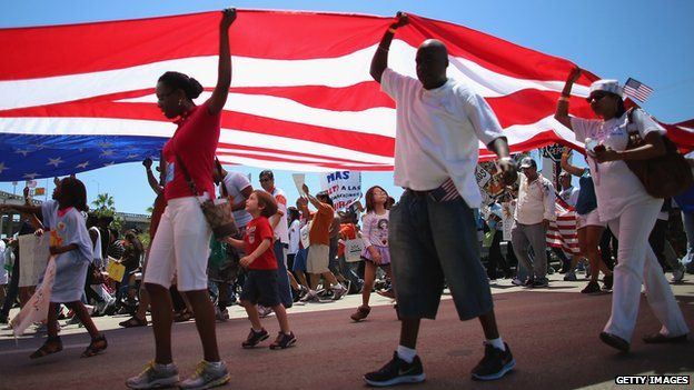 People participate in a protest march that organisers said was an attempt to get the US Congress to say yes to immigration reform 6 April 2013