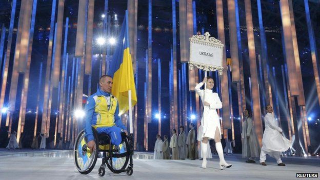 Ukraine's flag-bearer Mykhaylo Tkachenko arrives in the stadium during the opening ceremony of the 2014 Paralympic Winter Games in Sochi, on 7 March 2014