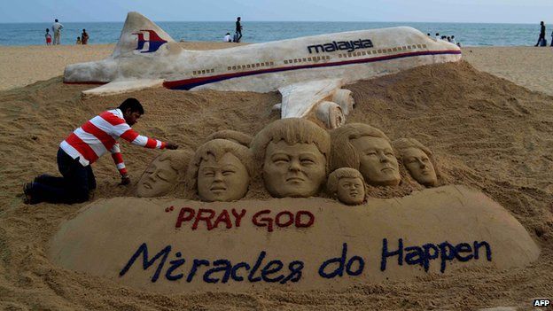 Indian sand artist Sudarshan Patnaik applies the final touches to a sand art sculpture on a beach in Puri, in the eastern Indian state of Odisha, 9 March
