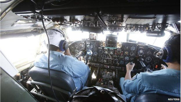 Military officers work within the cockpit of an aircraft AN-26 belonging to the Vietnam Air Force during a search and rescue mission off Vietnam's Tho Chu island March 10