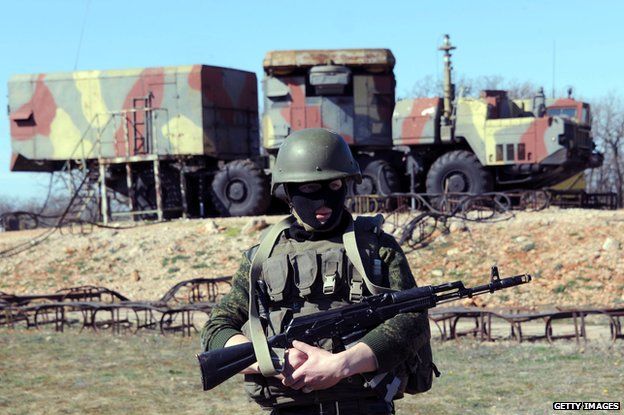 A member of the Russian forces guards in front of surface-to-air S300 missiles in a Ukrainian anti-aircraft missile unit on the Cape of Fiolent in Sevastopol on March 5, 2014