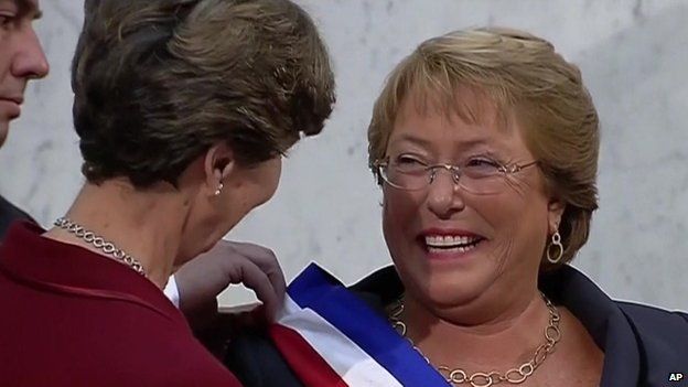 Michelle Bachelet (right) receives the presidential sash