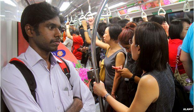 Commuters on a train in Singapore