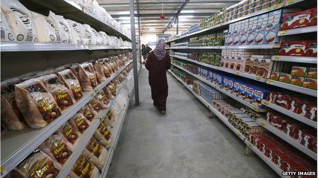 A Syrian refugee browses the aisles of the first supermarket to opened in Zaatari camp