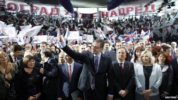 Serbian Deputy Prime Minister and the leader of Serbian Progressive Party (SNS) Aleksandar Vucic (C) waves to his supporters during a rally in Belgrade on 11 March 2014.