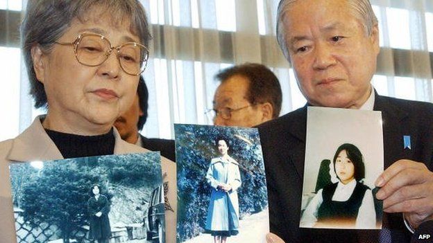 Shigeru and Sakie Yokota show portraits of their daughter Megumi at a press conference in Tokyo on 16 November 2004