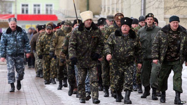 Cossacks, pro-Russian activists, march to take part in a rally outside the regional state administration building in Donetsk, eastern Ukraine, on 17 March 2014.