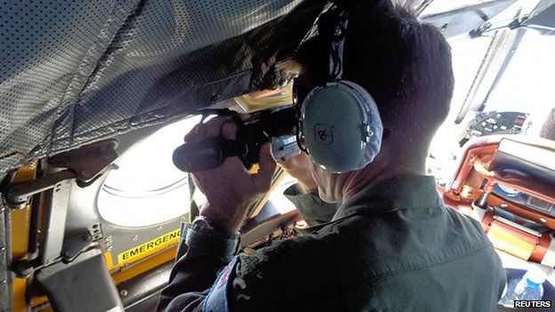 A Royal Australian Air Force crew member of an AP-3C Orion maritime patrol aircraft scans the surface of the sea near the west of Peninsula Malaysia on 17 March 2014