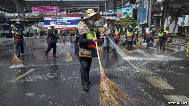 City workers clean the streets at major intersections after anti-government protesters relocated their protest to a central city park on 2 March 2014