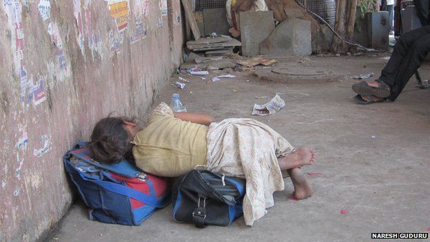 A girl sleeps on a street