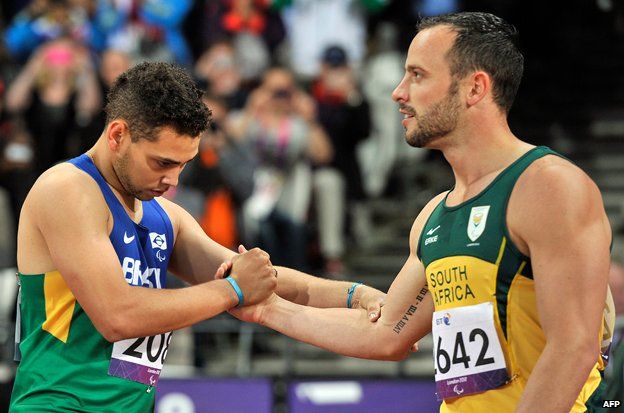 Brazilian Paralympian Oliveira is congratulated by Pistorius after the 200m race