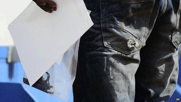 Police officer holds a bag containing the handgun allegedly used by Oscar Pistorius, February 2013