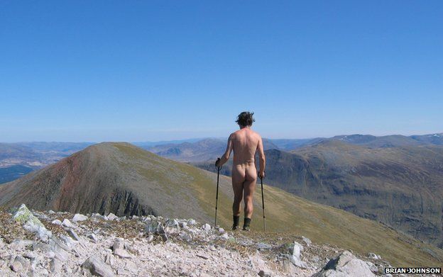 A naked man hiking