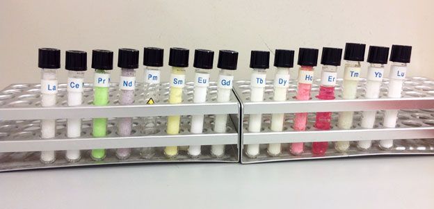 A rack of test tubes each showing various different colours